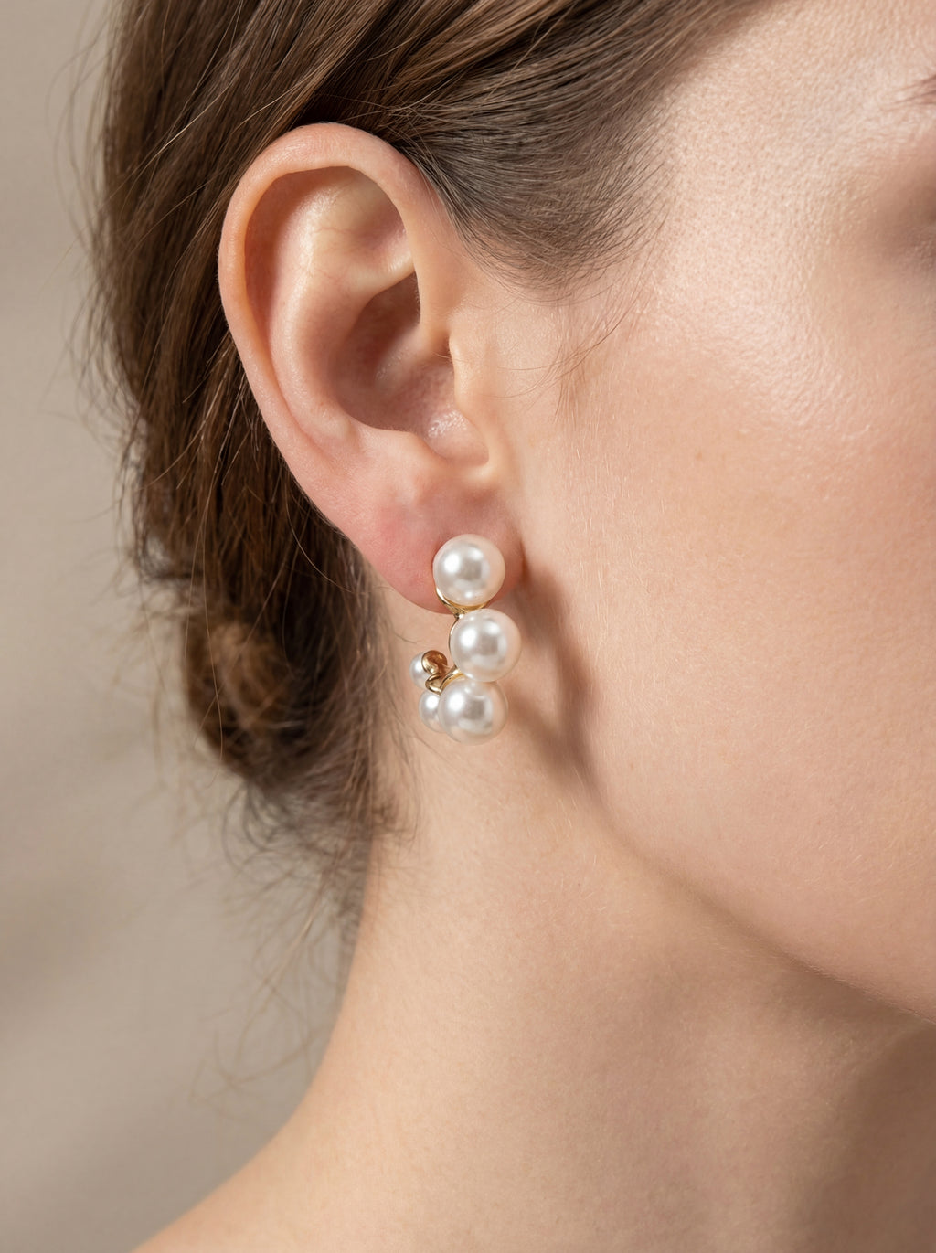 Person wearing pearl earrings 