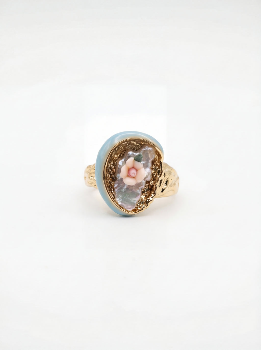 Ring with floral design and gold accents on a white background