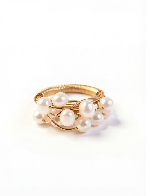 Gold ring with pearls on a white background