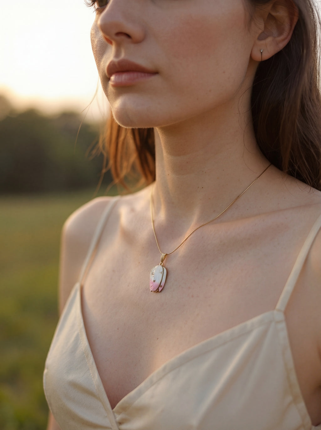 Woman wearing a necklace with a pendant in a natural setting