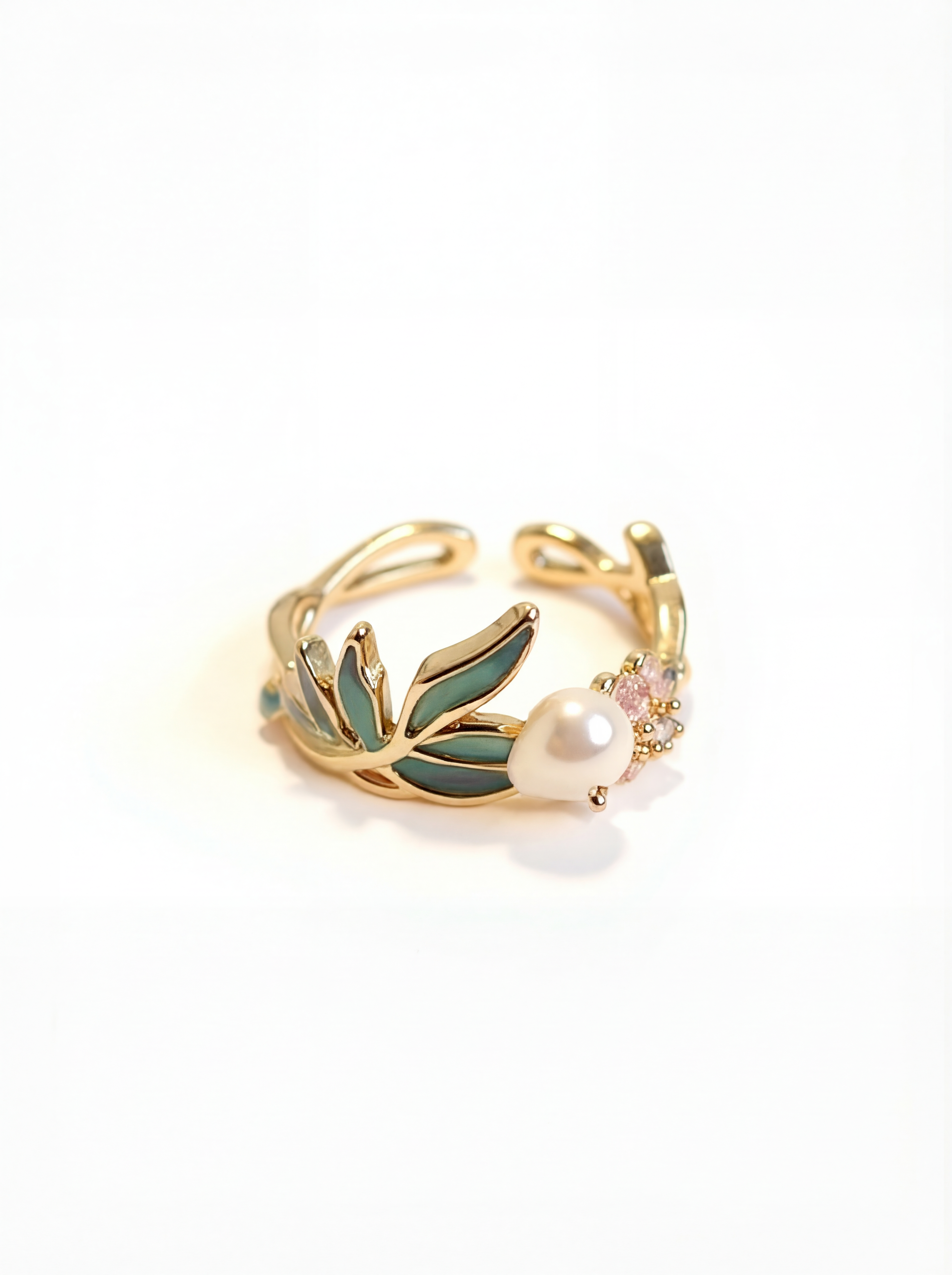 Gold ring with green leaves and a pearl on a white background