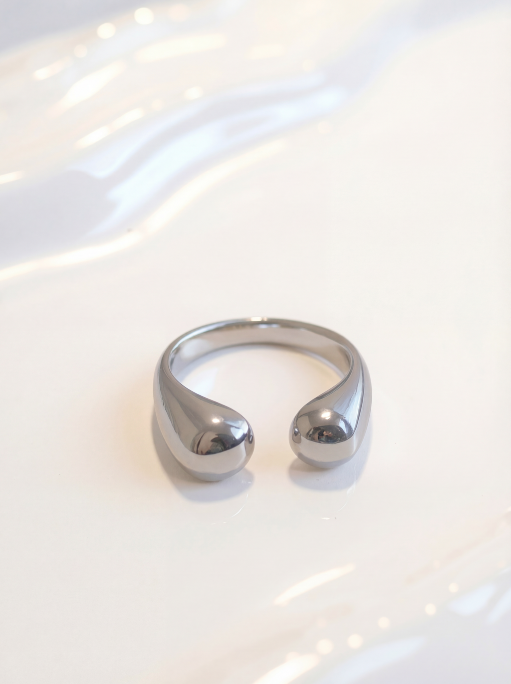 Silver ring on a white surface