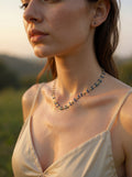 Woman wearing a necklace in a natural setting
