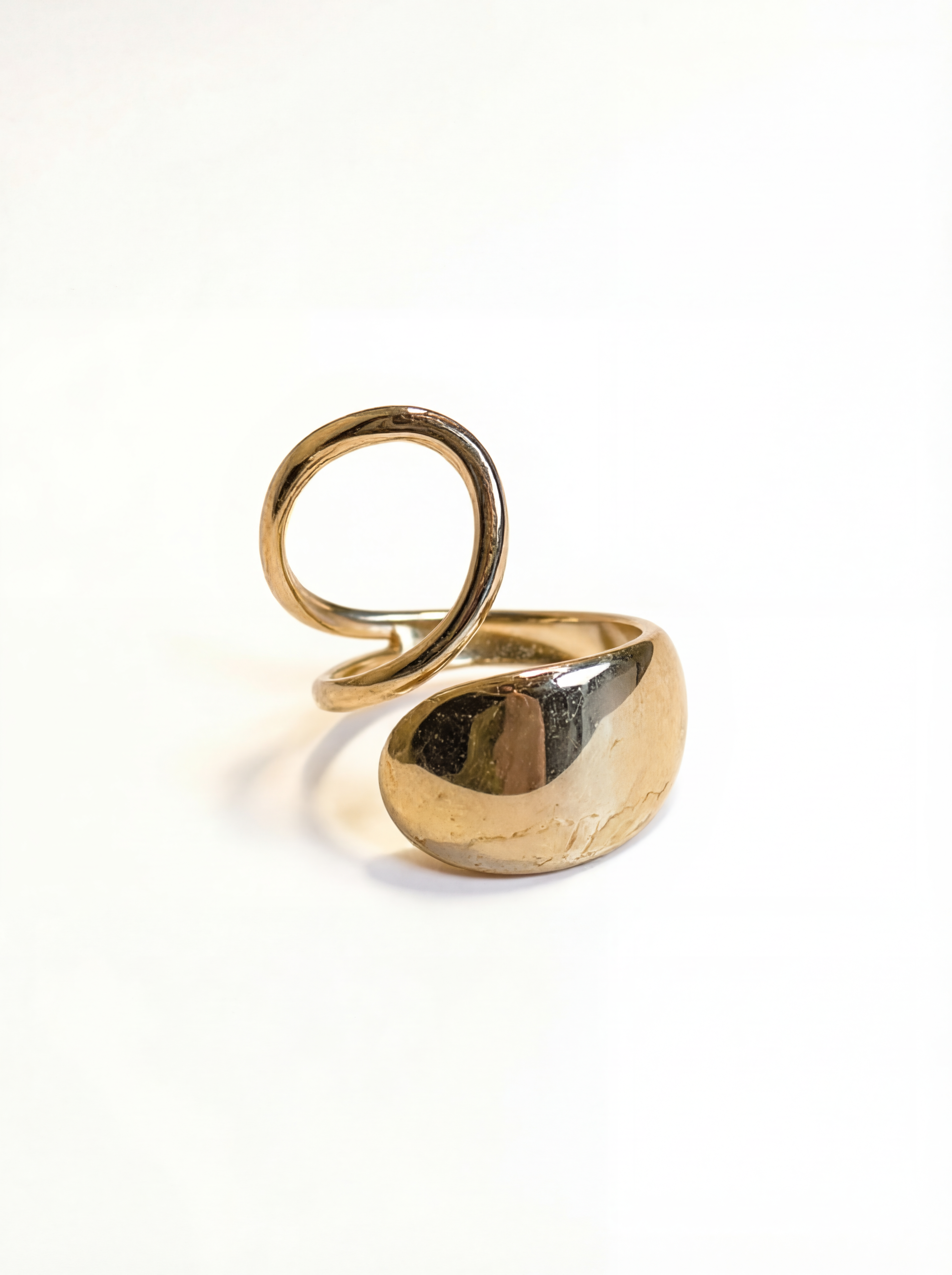 Gold ring with a unique design on a white background