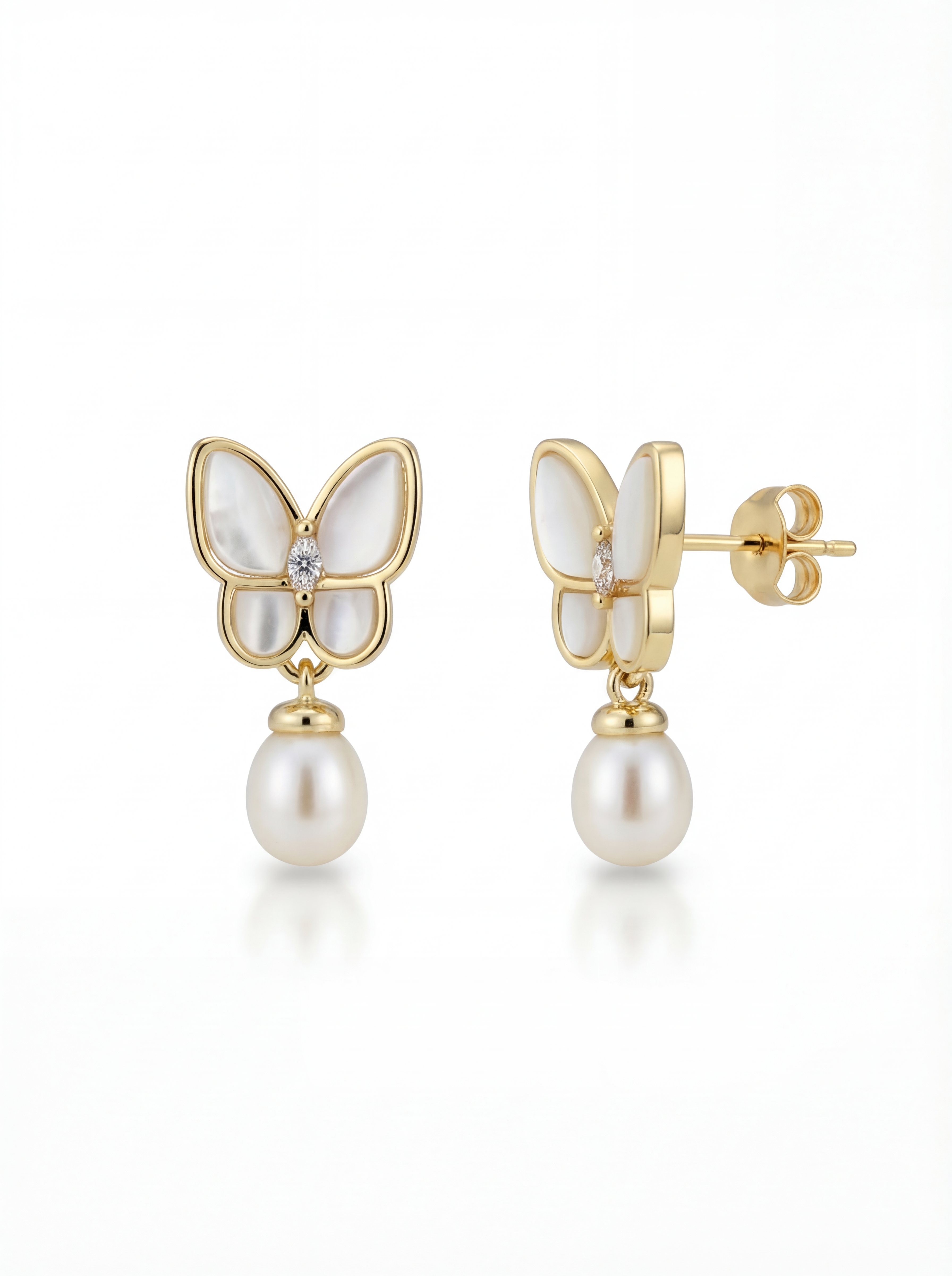 Butterfly-shaped earrings with pearl drops on a white background