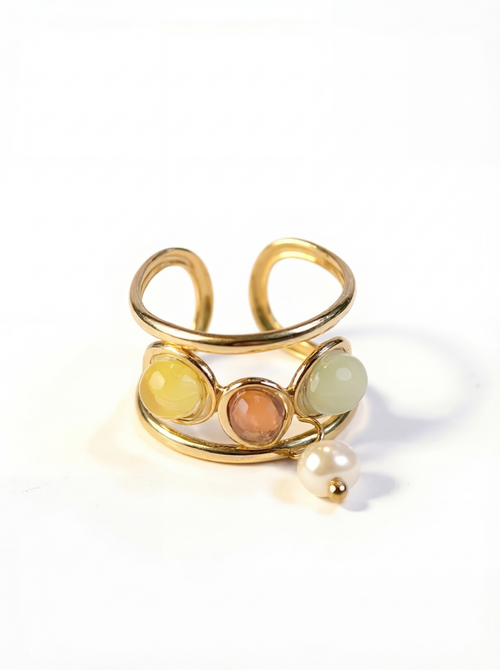 Gold ring with colored stones and a pearl on a white background