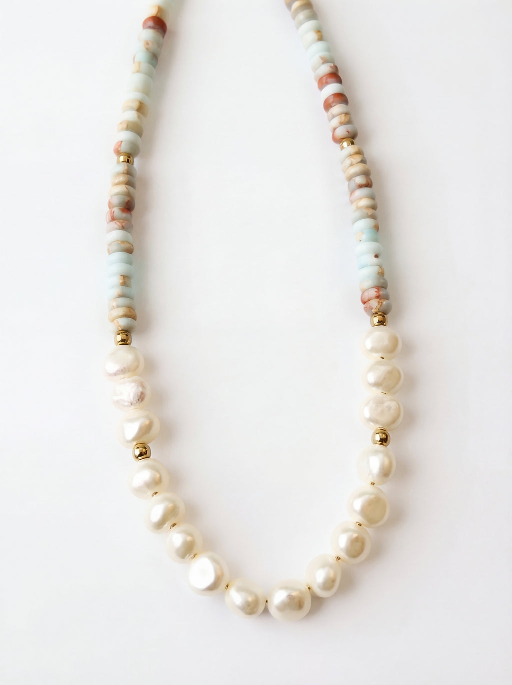 Necklace with pearls and multicolored beads on a white background