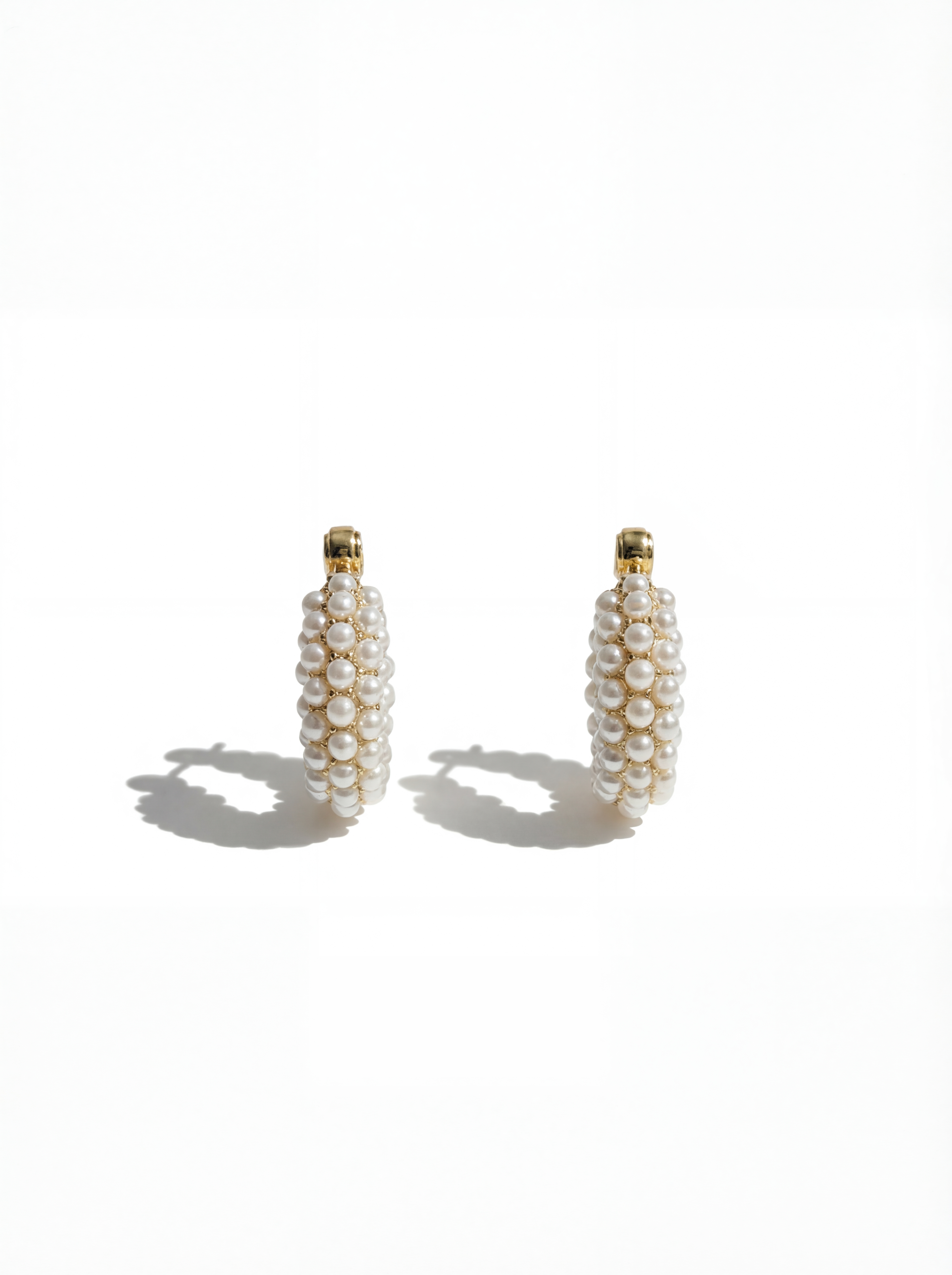Pair of pearl earrings on a white background