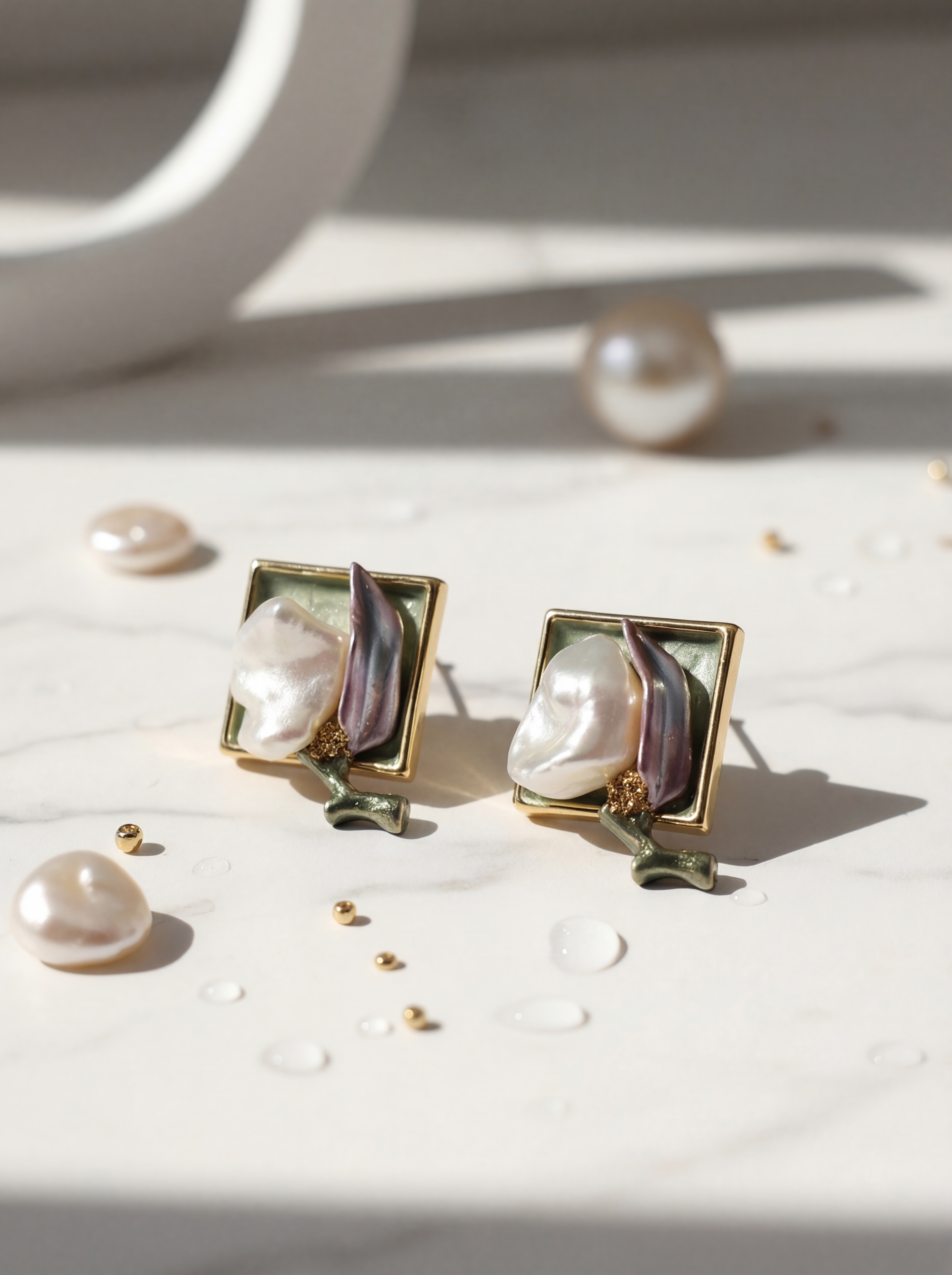 Pearl earrings with gold frames on a light surface