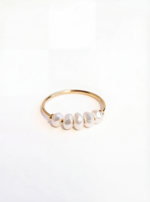 Gold ring with pearls on a white background