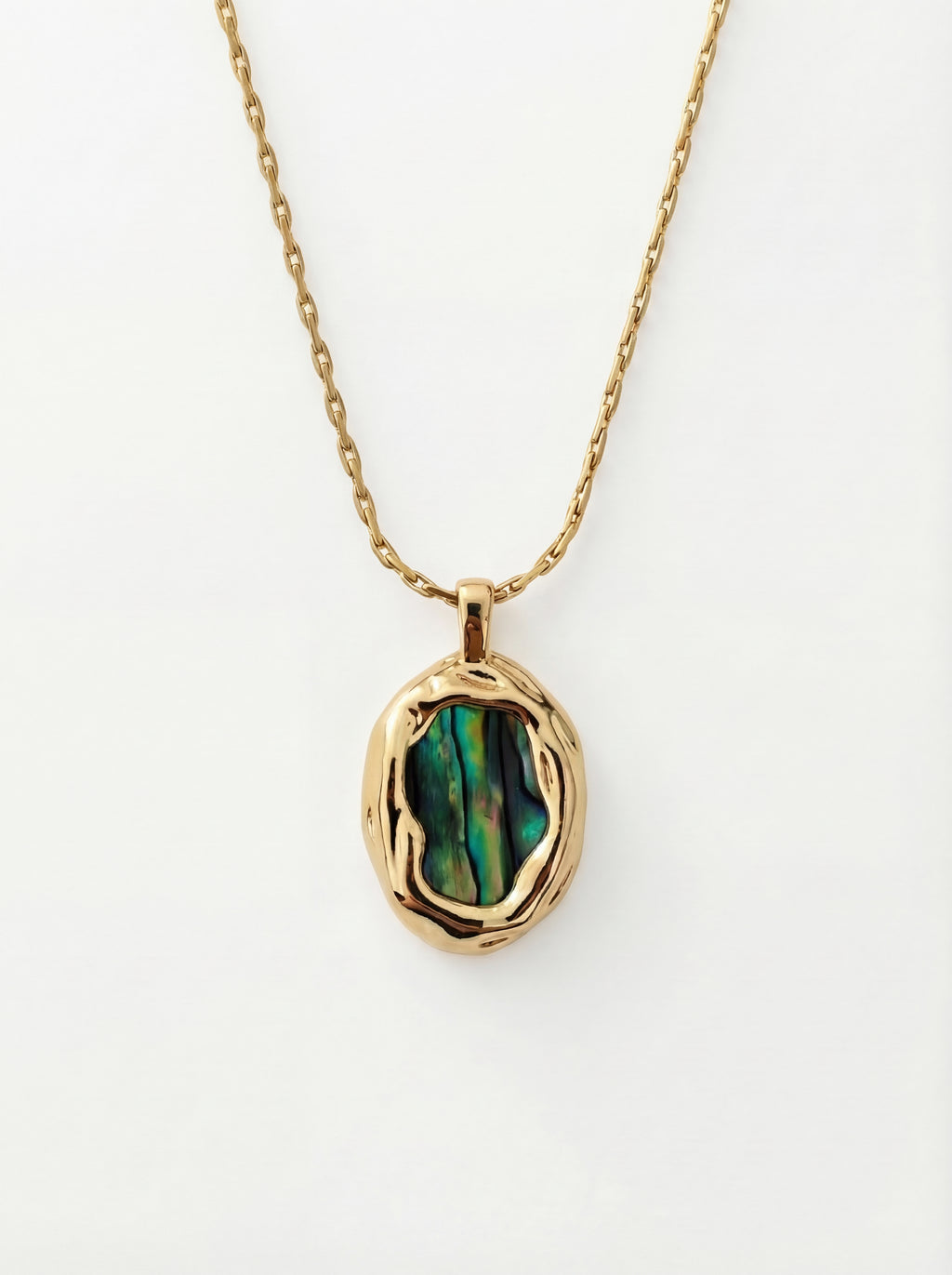 Gold necklace with a green stone pendant on a white background