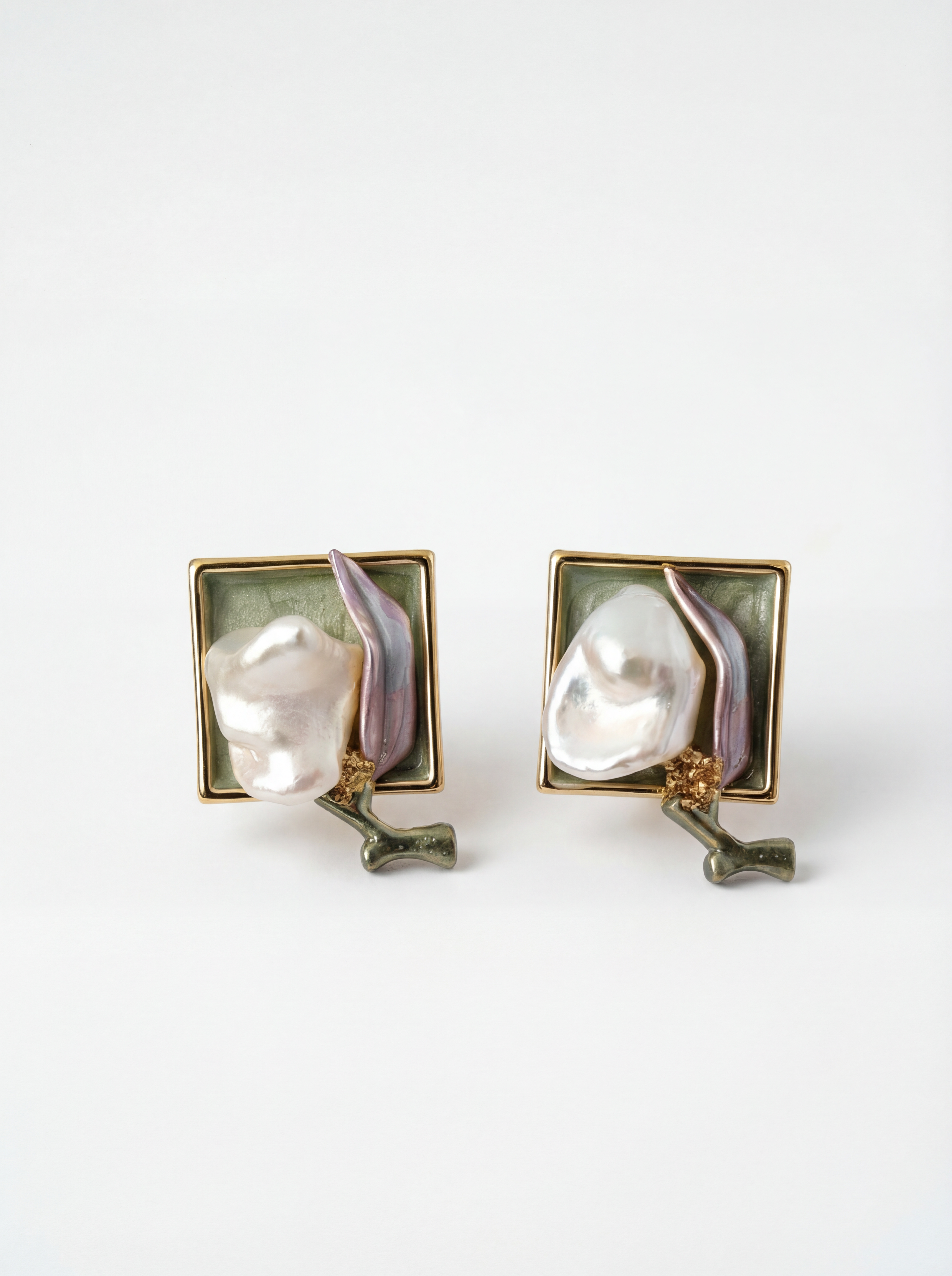 Pair of earrings with pearl-like centers on a white background