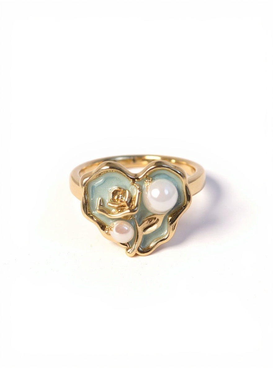 Gold ring with heart-shaped design and pearls on a white background