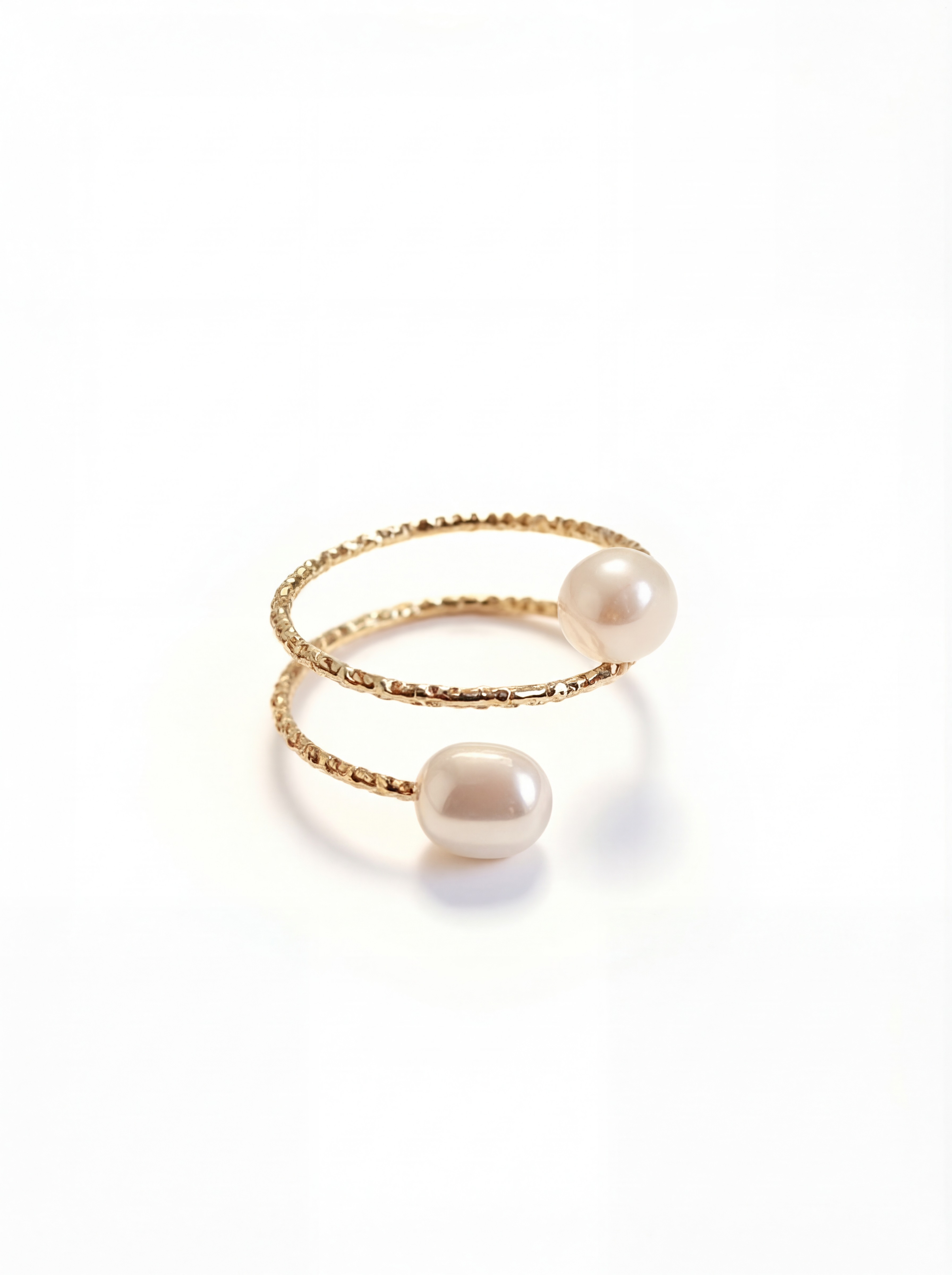 Two pearl rings on a white background
