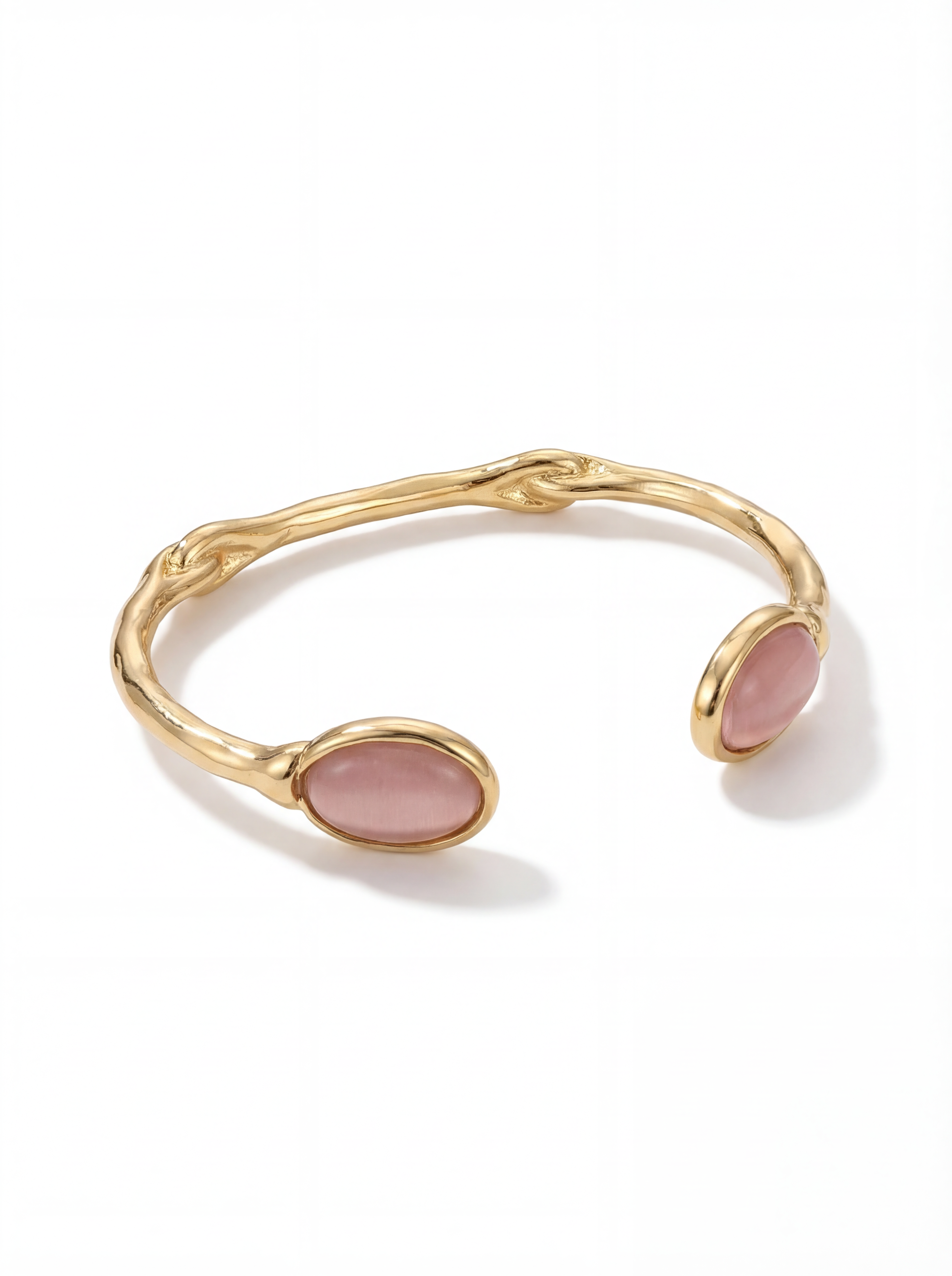 Gold bracelet with pink stones on a white background