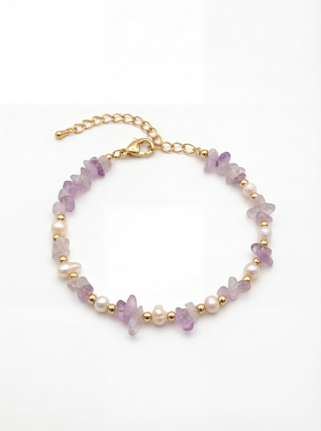 Bracelet with purple and gold beads on a white background
