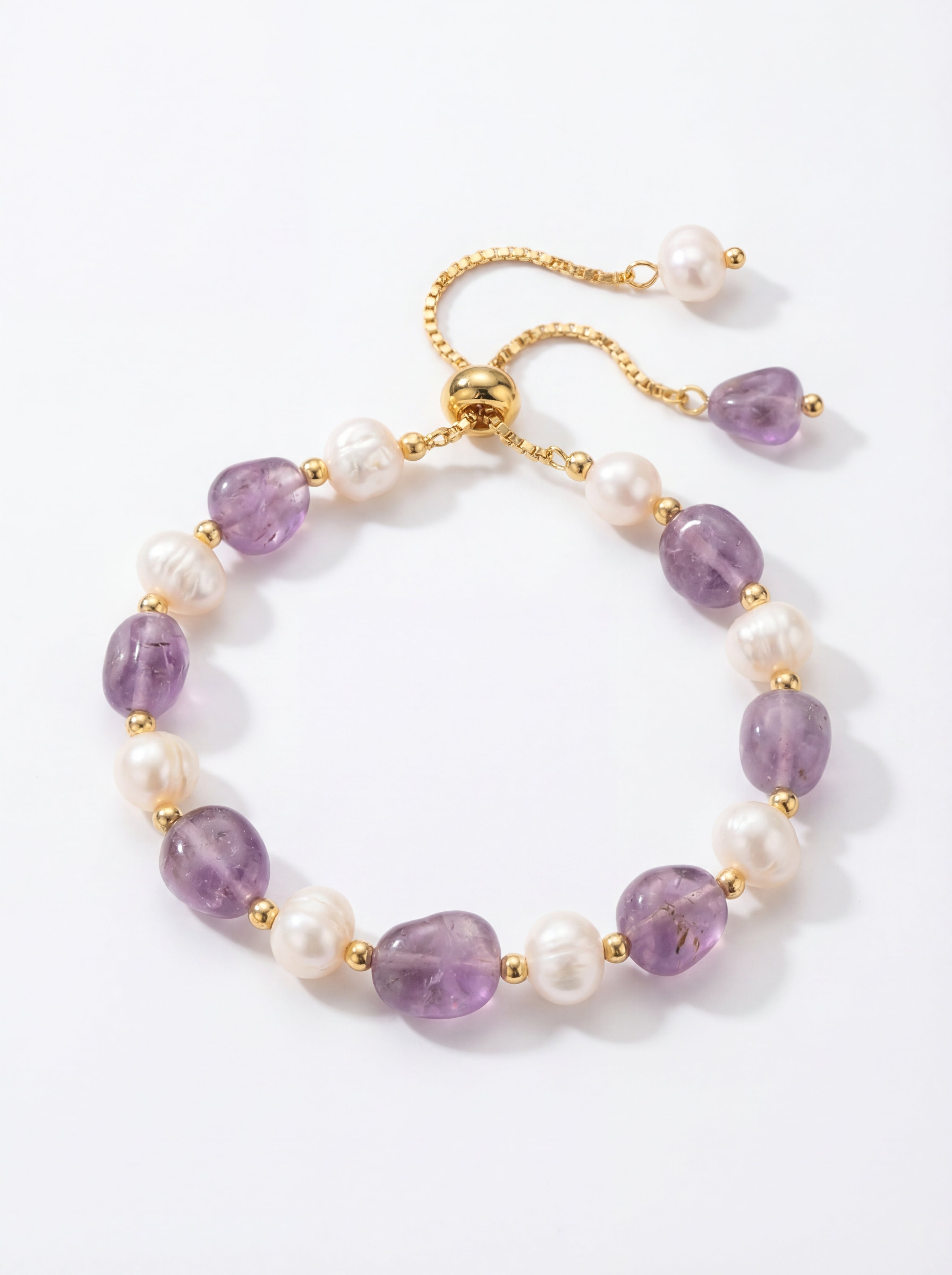 Bracelet with purple beads and pearls on a white background