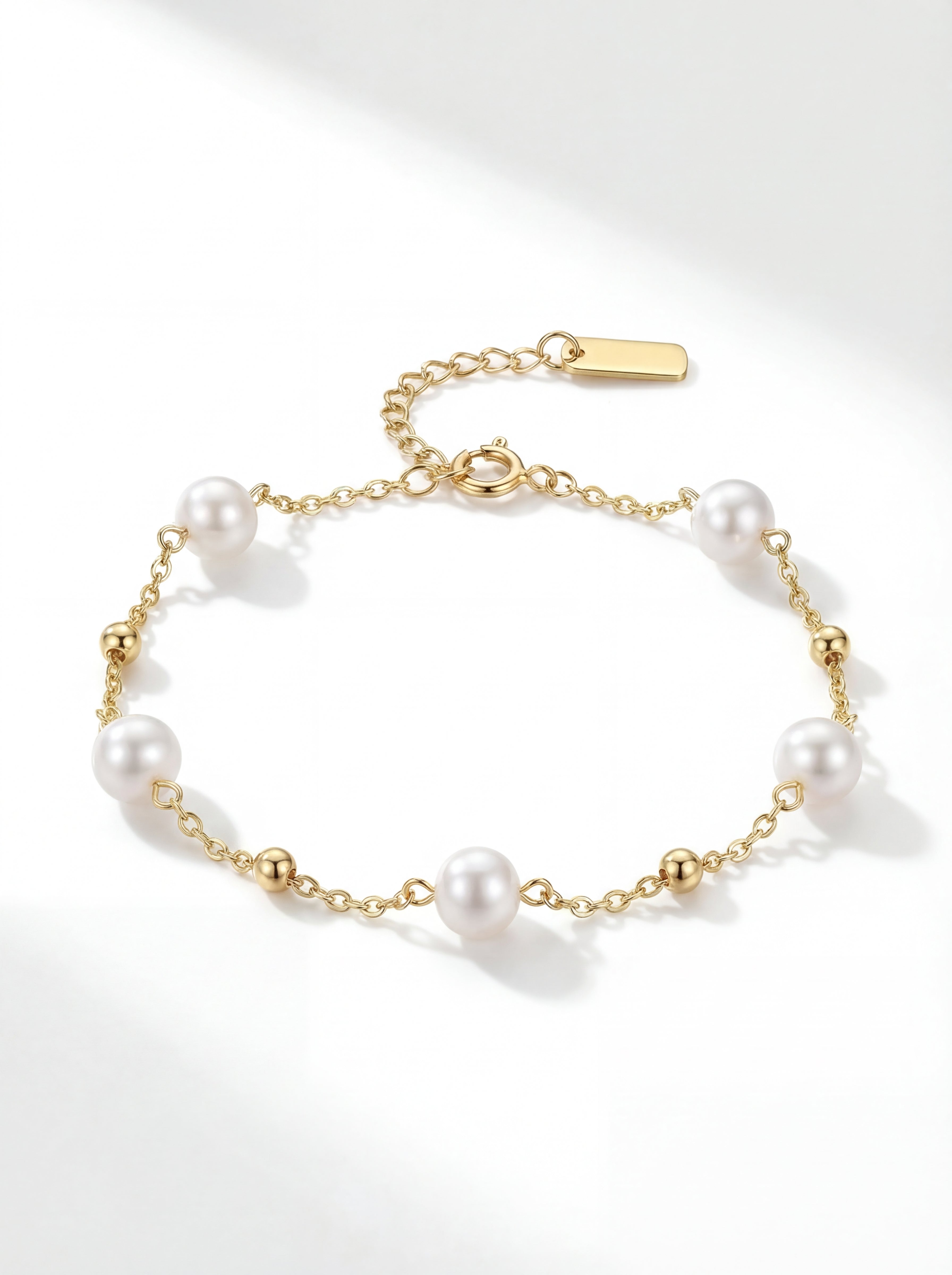 Pearl bracelet with gold chain on a white background