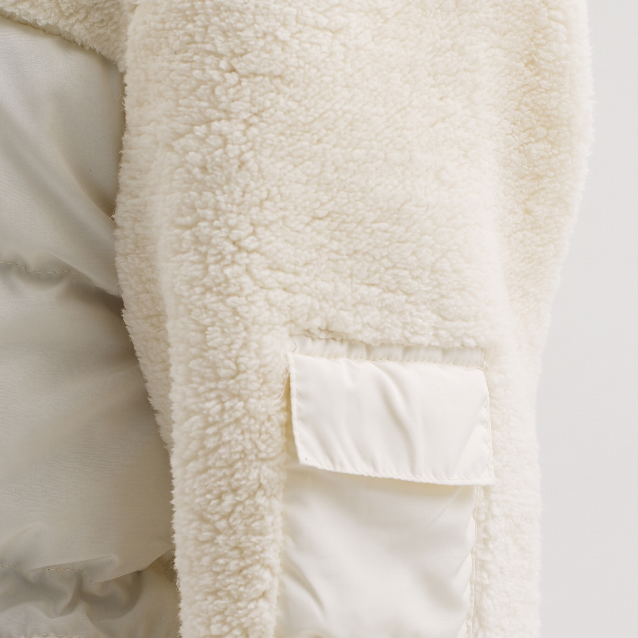 Weißer Hybrid-Steppmantel mit Stehkragen und Fleece-Einsätzen