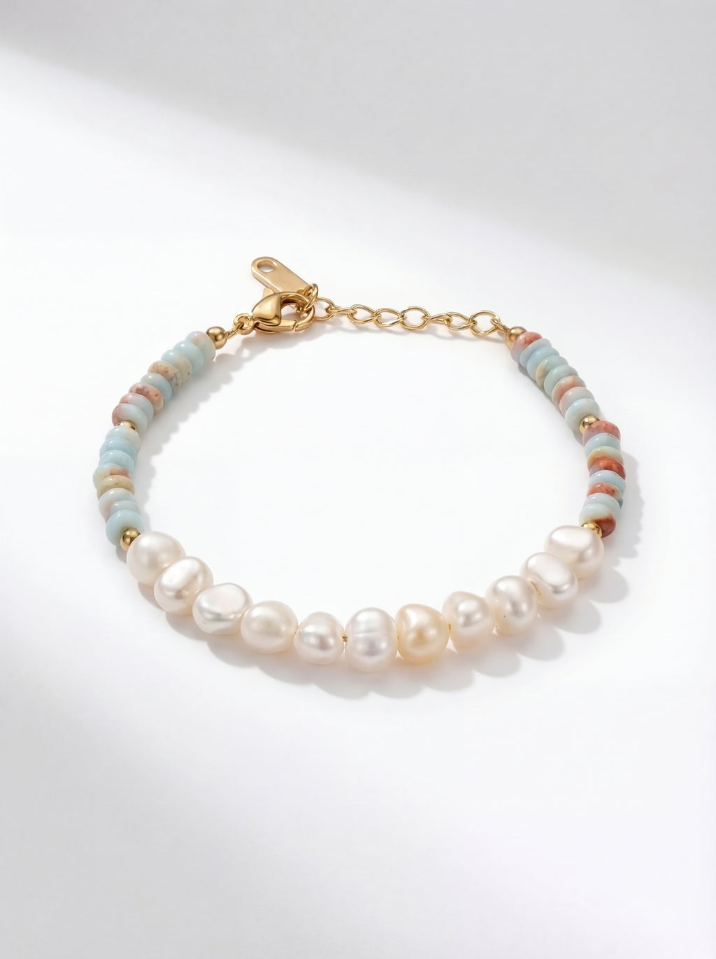 Pearl and bead bracelet on a light gray background