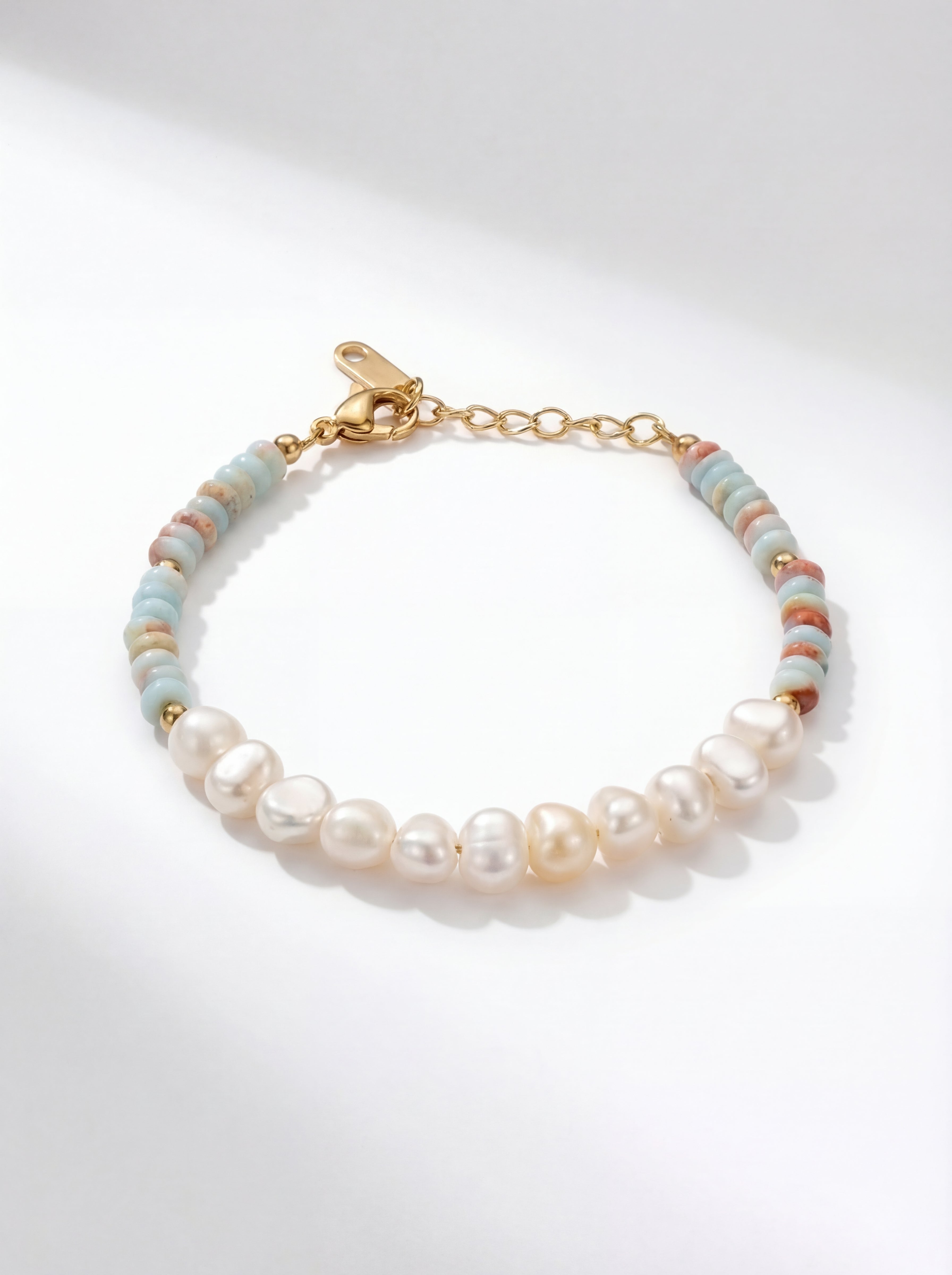 Pearl and bead bracelet on a light gray background