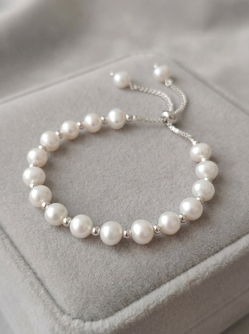 Pearl bracelet on a gray jewelry display box